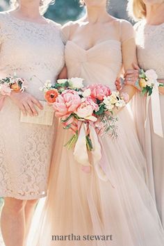 three bridesmaids in dresses holding bouquets and posing for the camera with each other