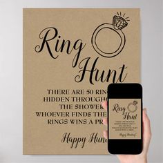 a person holding up a phone next to a sign that says, ring hunt there are 50 rings hidden through the shower