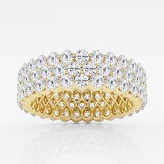 two tone gold and white diamond wedding ring with an intricate design on the center band