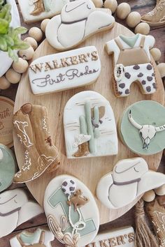 decorated cookies are arranged on a wooden platter with the words walker's first ride