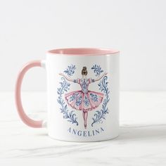 a pink and white coffee mug with an illustration of a ballerina on the front