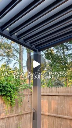 an outdoor patio with a metal roof and wooden fence in the background, there is a video screen showing how to install a pergol