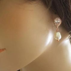 These simple yet statement-making sparkly dangle bridal earrings feature a high-quality Cubic zirconia drop and Swarovski teardrop pearl. They are available in rose gold and silver finishes, and the Swarovski pearls are available in white, ivory, or cream.The earrings measure about 25mm (1 inch) long, and the width is 8mm at the most significant point. Rose Gold Teardrop Earrings With Pearl Drop, Rose Gold Drop Earrings With Pearl Detail For Bridal, Rose Gold Teardrop Pearl Earrings For Wedding, Rose Gold Bridal Drop Earrings With Pearl, Rose Gold Teardrop Pearl Earrings For Anniversary, Rose Gold Teardrop Pearl Earrings For Party, Metal Hair Accessories, Comb Veil, Drop Pearl Earrings