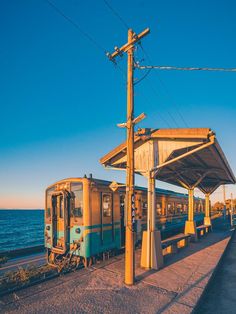 the train is stopped at the station by the water