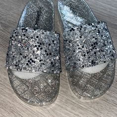 Jeweled Sandals, New Never Worn, Great Condition, Perfect For Night Out Or Occasion. Fits Like A Size 7.5 Silver Round Toe Flip Flops For Party, Silver Open Toe Flip Flops For Party, Party Silver Synthetic Flip Flops, Flat Synthetic Jelly Sandals For Party, Glitter Round Toe Jelly Sandals For Party, Silver Slide Sandals For Beach, Silver Slide Sandals For The Beach, Open Toe Glitter Sandals For Beach, Bling Nike