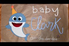 a baby shark with a party hat on it's head and the words baby clark written in blue