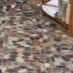 a bathroom with stone flooring next to a sink