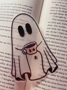 a ghost sticker on top of an open book