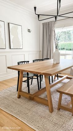 a dining room table and benches in front of a window