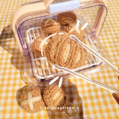 a person is holding some crocheted items in their hand and they are sitting on the table