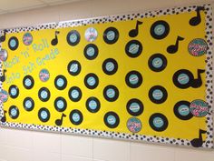 a yellow bulletin board with black and white polka dots