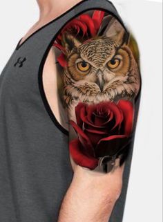 an owl and rose tattoo on the left upper half of the arm, with red roses around it