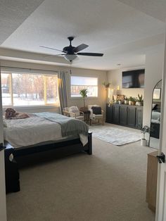 a bedroom with a large bed and ceiling fan in it's centerpieces