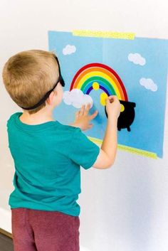 a little boy that is standing in front of a painting