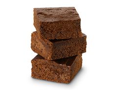 three pieces of brownie stacked on top of each other in front of a white background