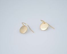 "14K solid gold earrings. 14K solid gold tiny disc earrings. Tiny gold disc earrings. Simple earrings. Dainty earrings. Gift for her. These earrings are simple and can be worn everyday. * 14K solid gold disc is 3/8\", 22 gauge. Please select yellow gold or white gold. * 14K solid gold ear wire The earrings will be shipped in a nice gift box. To see add-on click on the link below. https://www.etsy.com/shop/SashJewelry?section_id=12359884 To see more children's jewelry click on the link below. htt Dainty Yellow Gold Circular Earrings, Dainty Circle Earrings In 14k Gold, Simple 14k Gold-filled Round Earrings, 14k Gold Circle Earrings For Gifts, Simple 14k Gold Filled Earrings, Simple 14k Gold Filled Round Earrings, Tiny Modern Gold Earrings, Simple Round 14k Gold Filled Earrings, Dainty 14k Gold Circle Earrings