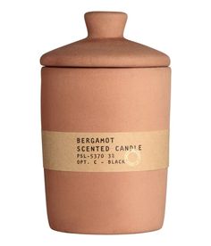 bergamot scented candle in terracotta with label on the front and bottom