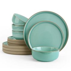 a stack of green dishes with gold rims