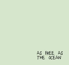 a green wall with the words as free as the ocean written on it in black ink