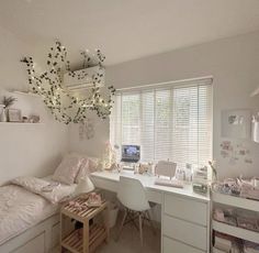 a bedroom with white furniture and lots of decorations on the ceiling, along with a desk