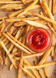 french fries with ketchup and mustard on a tray