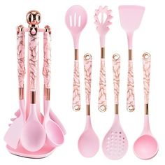 pink kitchen utensils and spoons are lined up on a white background with gold accents