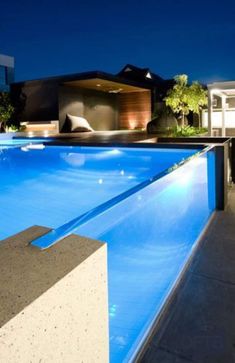 an empty swimming pool at night with lights on