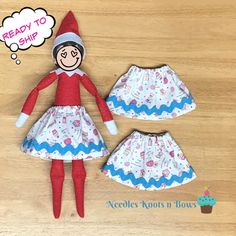 an elf doll is wearing a dress and hat with cupcakes on the bottom