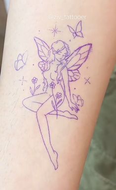 a tattoo on the leg of a woman with a fairy tinkerbell sitting on top of it