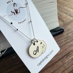 a timeless sterling silver script letters charms hang from elegant sterling silver satellite chain. all findings are sterling silver. 16'' with 2'' extender.sterling silver disc-13mm*only available in sterling silver***Please indicate the following information in the "message to seller" box at the checkout..1. 2 initials of your choicehere's more personalized options for your bridal party.http://www.etsy.com/shop/thejewelrybar?section_id=7033278 Personalized Adjustable Sterling Silver Initial Necklace, Adjustable Sterling Silver Initial Pendant Necklace, Personalized Sterling Silver Initial Necklace, Silver Dangle Jewelry With Custom Name, Sterling Silver Monogram Charm Necklace For Mother's Day, Mother's Day Sterling Silver Initial Pendant Charm Necklace, Silver Custom Name Charm Necklace For Everyday, Mother's Day Sterling Silver Monogram Charm Necklaces, Mother's Day Sterling Silver Charm Necklaces