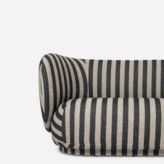 a black and white striped couch sitting on top of a wooden floor