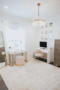 a white desk with a computer on top of it next to a dresser and chair