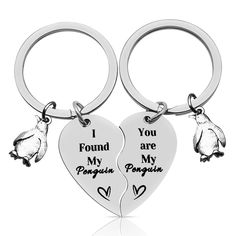 two heart shaped key chains with penguins and i found you are my penguin friend on them