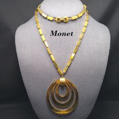 *Description: This is a beautiful Monet necklace, Tournee, a popular pendant necklace from the 1960s. This necklace is featured on page 161 of the Monet The Master Jewelers by Alice Vega. Vega explains that the fashion and accessories of the 1960s were more casual and carefree in feeling. This beautiful box chain pendant necklace is gold plated and has a long length at 29 inches with a large 3 inch pendant. This would be a great addition to your vintage jewelry collection or make a great vintage 70s Jewelry, Monet Necklace, 1960s Jewelry, Book Pieces, Pendant Necklace Gold, Monet Jewelry, Funky Jewelry, Jewelry Lookbook, Brass Necklace