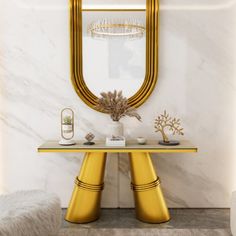 a gold console table with a mirror and vase on it in front of a marble wall