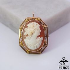 "Metal: 10k Yellow Gold Weight: 6.12 grams Measurements: 1.15\" Long; 0.92\" Wide Shell: Carnelian *Expertly hand-carved with high relief, this beautiful carnelian shell cameo brooch features an image of a smiling woman looking off to the right with her hair tied up. The piece is set into an ornately designed filigree 10k white gold bezel. This outstanding Victorian cameo is in beautiful condition, with some wear. The clasp works nicely. A truly extraordinary addition to any collection, this spe Heirloom Style Carved Brooch For Gifts, Heirloom Carved Brooches As Gift, Ornate Carved Collectible Brooches, Carved Yellow Gold Brooches, Victorian Cameo, Smiling Woman, Tacoma Wa, Aesthetic Pastel, Woman Looking