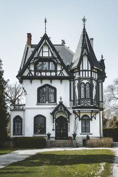 a large white and black house with lots of windows