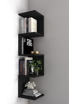 three black shelves with books on each shelf