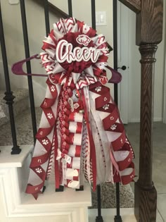 a red and white bow with the word cheer on it sitting on top of stairs