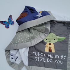 a star wars themed bag with a baby yoda on it and a butterfly sitting next to it