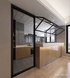 an empty kitchen with glass walls and wooden cabinets