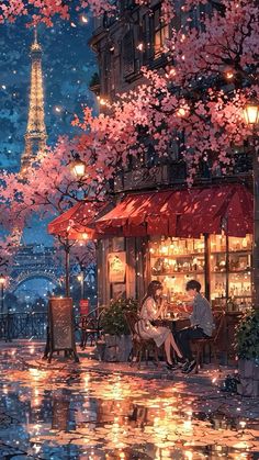 two people sitting at an outdoor cafe under the lights of the eiffel tower