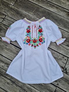 Traditional Hungarian Matyó floral handembroidered blouse . This blouse is new. Peasant blouse, colorful peasant blouse, embroidered blouse, embroidered peasant blouse, floral blouse, ethnic embroidered blouse Beautiful wide shape boho, hippie, folk blouse with floral embroidered pattern.  Handmade blouse  Length: 26" Bust : 44 - 45"  inch Hand wash only. If you are buying several pieces I can combine postage at the time of mailing. If you have any question please don't hesitate to contact me, Summer Folk Peasant Top With Embroidered Sleeves, Traditional Spring Blouse With Machine Embroidery, Spring Folk Style Peasant Tunic Top, Spring Folk Tunic Peasant Top, Spring Folk Peasant Tunic Top, Spring Multicolor Embroidered Peasant Top, Spring Folk Style Tops With Machine Embroidery, Folk Style Spring Tops With Machine Embroidery, Spring Folk Tops With Machine Embroidery