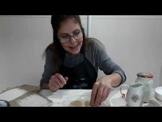 a woman sitting at a table making food