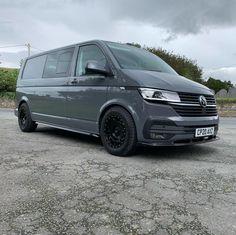 a grey van is parked in the parking lot