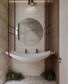 a white sink sitting under a mirror next to a wall mounted faucet in a bathroom