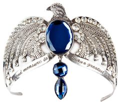 a blue bird brooch sitting on top of a white table