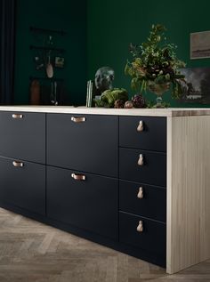 a black dresser with gold handles and drawers