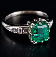 14k White Gold Emerald Solitaire Engagement Ring W/ Diamond Accents 2.21ctwMetal Information: 14k White GoldTotal Weight: 3.42gBand Width: 1.3mmSize: 6.25Additional Information: Emerald Has Visible InclusionsStone InformationMain StoneGem Type: EmeraldShape: Emerald (7.8mm x 6.9mm)Color: GreenClarity/Quality: ACarat Weight: 1.96ctNumber of Stones: 1Accent StonesGem Type: DiamondShape: Emerald (2.4 x 2mm - 1.8mm x 1.5mm)Color: HClarity/Quality: SI1Carat Weight: .042ctNumber of Stones: 6Total esti Classic Platinum Gemstones Gia Certified, Gia Certified Platinum Classic Gemstones, Classic Gia Certified Platinum Gemstones, Classic Gia Certified Emerald Cut Gemstones, Platinum Channel Set Baguette Cut Jewelry, Heirloom Style Gia Certified Emerald Cut Jewelry, Classic Round Cut Channel Set Emerald Ring, Heirloom 14k White Gold Jewelry, Gia Certified, Fine Jewelry Emerald Ring With Channel Set