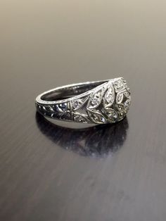 DeKara Designs Collection Metal- 90% Platinum, 10% Iridium.Stones- 24 Round Diamonds, G Color VS1 Clarity, 0.41 Carats.A true masterpiece handmade hand engraved 90 percent platinum ring/band.  The ring has 24 diamonds with 18 of them being pave set and 6 of them bezel found on the side of the rings top gallery, all with G color and VS1 clarity totaling to .41 carats.  The ring is entirely hand engraved and also double mili grained on the sides and all throughout the top.  This could be a great a Oval Wedding Diamond Ring With Single Cut Diamonds, Oval Diamond Ring With Single Cut Diamonds For Wedding, Oval Single Cut Diamond Wedding Ring, Platinum White Gold Rings For Wedding, Heirloom Platinum Jewelry For Marriage, Platinum White Gold Wedding Rings, Platinum Rings For Marriage With Round Band, White Gold Platinum Wedding Rings, Round Cut Diamond Marriage Ring